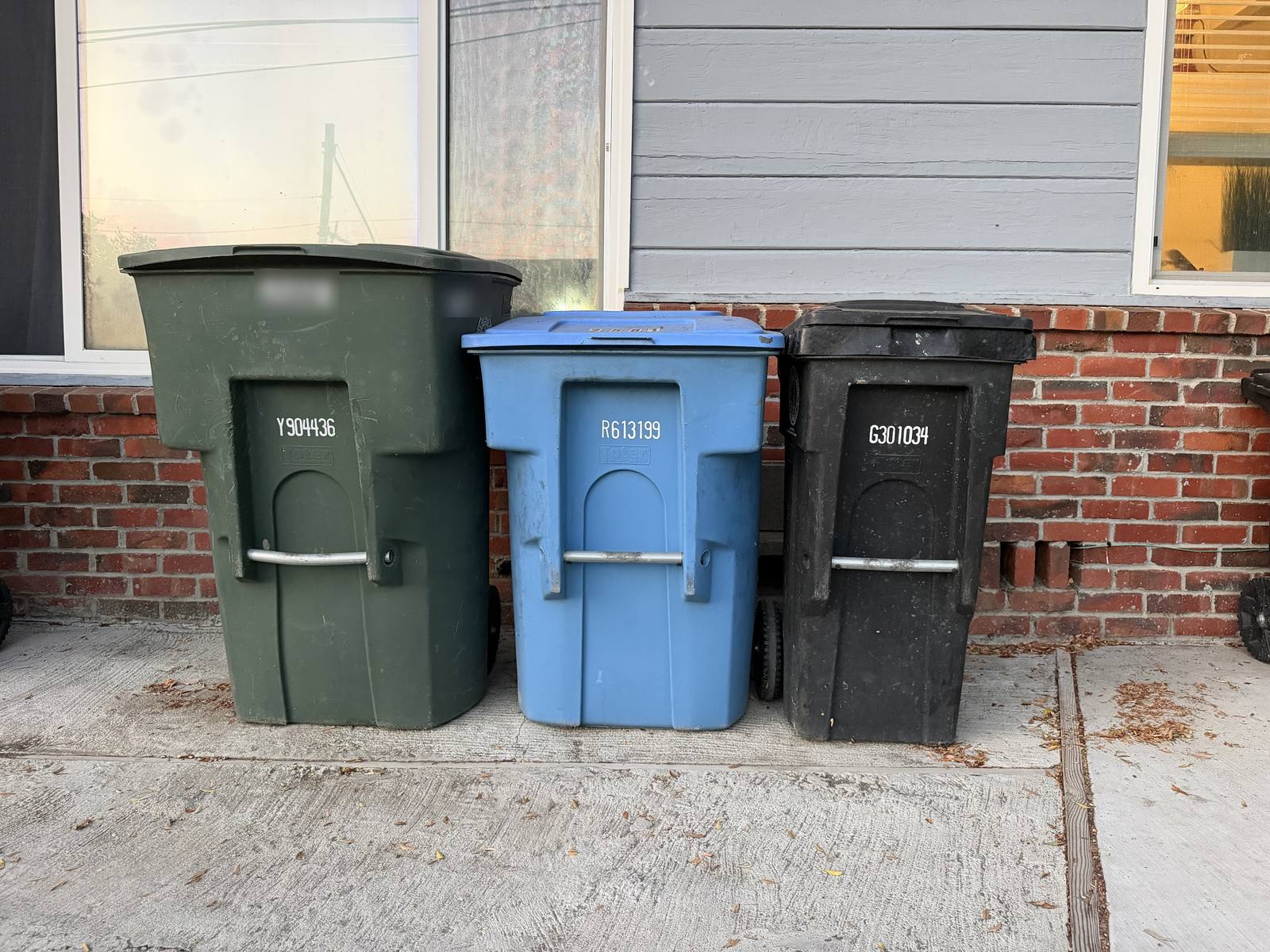 A garbage, recycling, and compost cart lined up beside a Palo Alto home